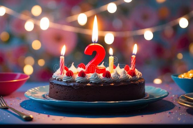 nd-birthday-cake-number-burning-candle-table-blurred-lights-